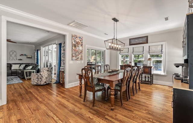 2649 Starfish Dr, Johns Island, SC 29455 - dining area with a chandelier, light wood finished floors, baseboards, and ornamental molding