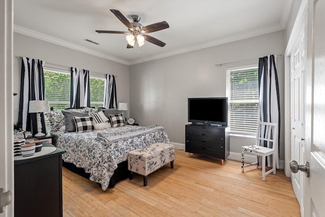 2649 Starfish Dr, Johns Island, SC 29455 - bedroom with multiple windows, light wood finished floors, crown molding, and a ceiling fan