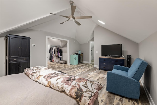 2649 Starfish Dr, Johns Island, SC 29455 - bedroom with light wood-style floors, a walk in closet, vaulted ceiling, a closet, and ceiling fan
