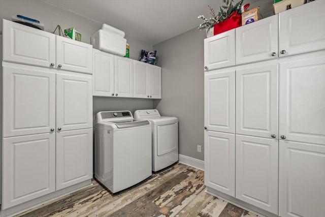2649 Starfish Dr, Johns Island, SC 29455 - laundry area featuring washing machine and clothes dryer, cabinet space, light wood-style floors, and baseboards