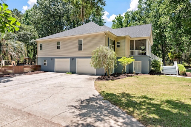 2649 Starfish Dr, Johns Island, SC 29455 - view of front of home featuring an attached garage, concrete driveway, a front yard, stairway, and a shingled roof
