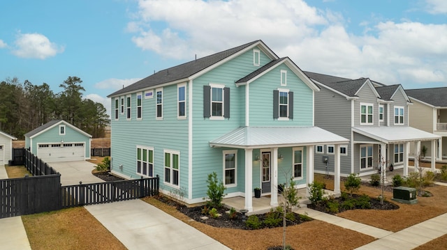 view of front of home featuring a garage, an outdoor structure, and a porch