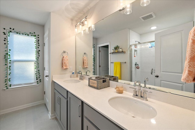 bathroom with tile patterned flooring, vanity, and walk in shower