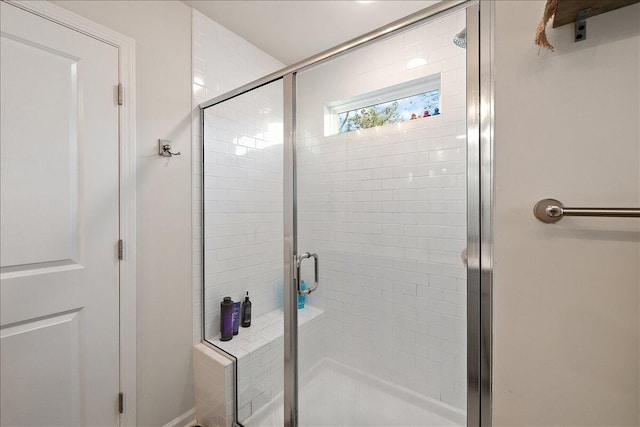 bathroom with a shower with shower door