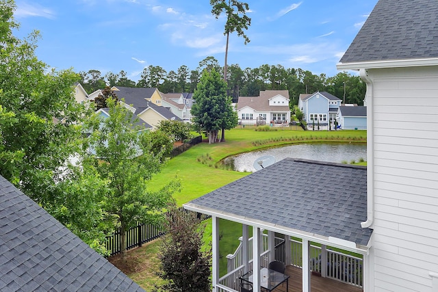 exterior space featuring a water view and a lawn