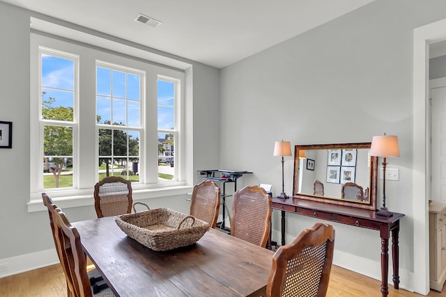 dining area with light hardwood / wood-style flooring and a wealth of natural light