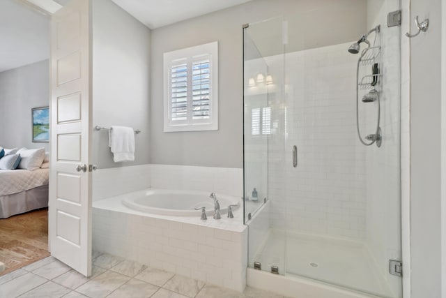 bathroom featuring plus walk in shower and tile patterned flooring