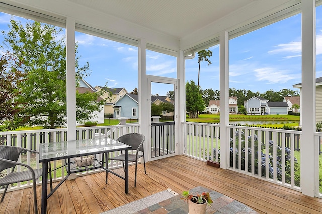 sunroom / solarium with a water view