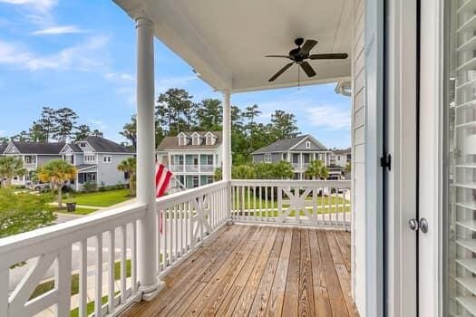 wooden deck featuring ceiling fan