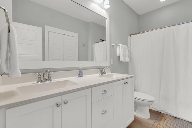 bathroom with tile patterned floors, toilet, and vanity