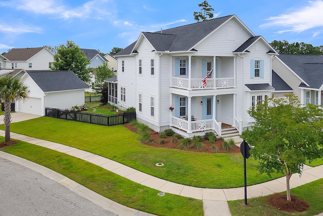 view of front facade featuring a garage, a balcony, an outdoor structure, a front yard, and covered porch