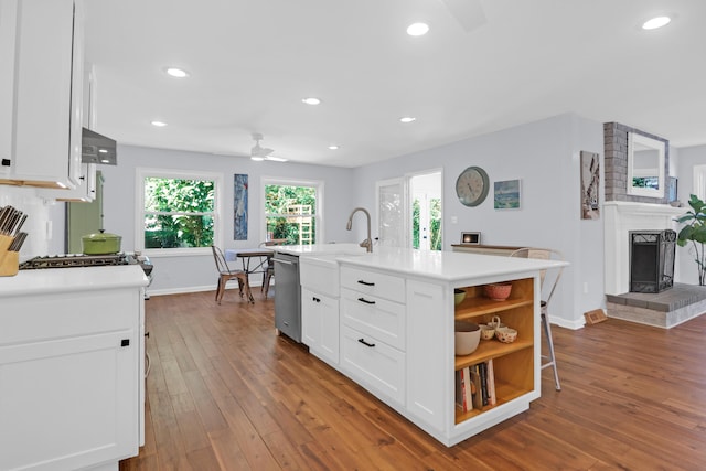 kitchen featuring ceiling fan, open shelves, stainless steel dishwasher, and white cabinetry
