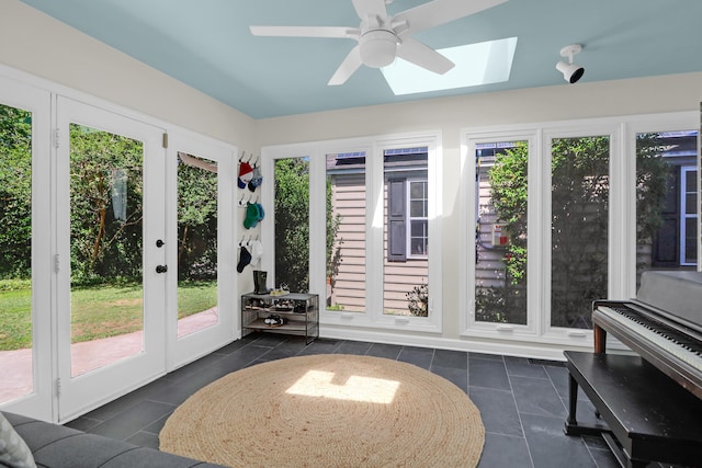 sunroom / solarium with a skylight, french doors, and tile patterned floors
