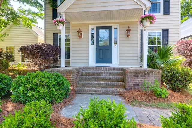 view of exterior entry with a porch