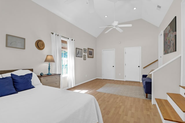 bedroom with a ceiling fan, high vaulted ceiling, visible vents, and light wood-type flooring