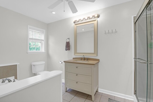 bathroom with vanity, toilet, ceiling fan, tile patterned floors, and a shower stall