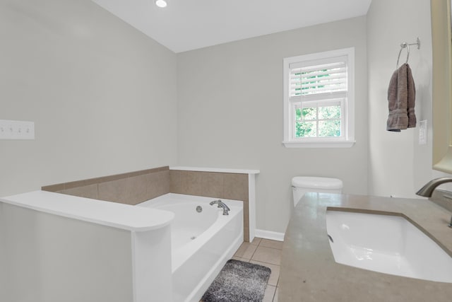 bathroom with tile patterned flooring, baseboards, a bath, and vanity