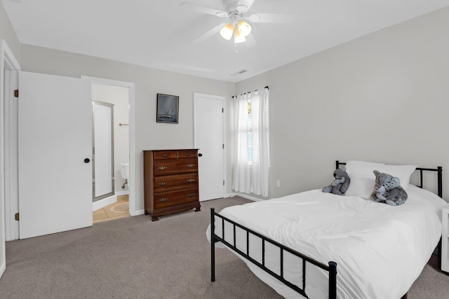 bedroom featuring light carpet, a ceiling fan, connected bathroom, and visible vents