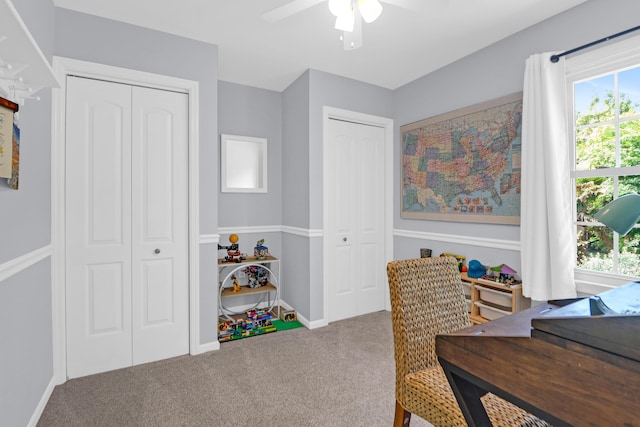 carpeted home office with baseboards, a ceiling fan, and a wealth of natural light