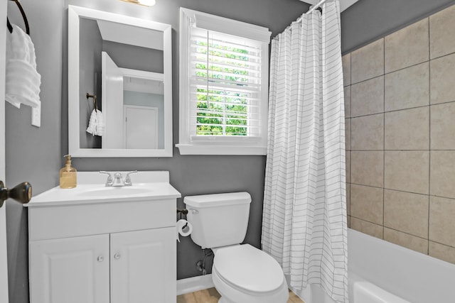 bathroom featuring vanity, shower / bath combo, and toilet