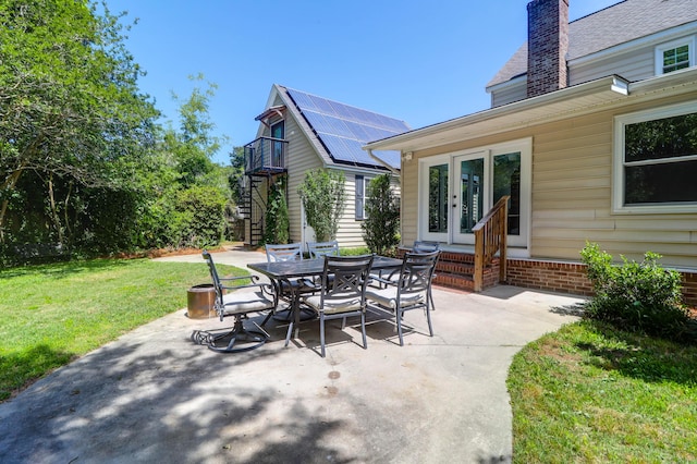 view of patio with french doors, stairs, outdoor dining area, and entry steps