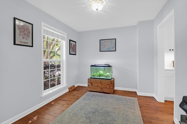 unfurnished room featuring baseboards and wood finished floors