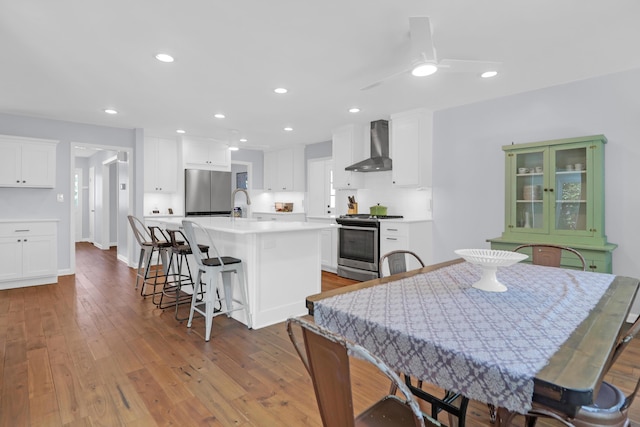 dining room featuring recessed lighting, baseboards, ceiling fan, and hardwood / wood-style flooring