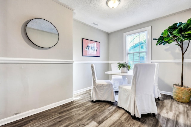 2674 Houston St, North Charleston, SC 29405 - dining space featuring wood finished floors, a textured ceiling, and baseboards