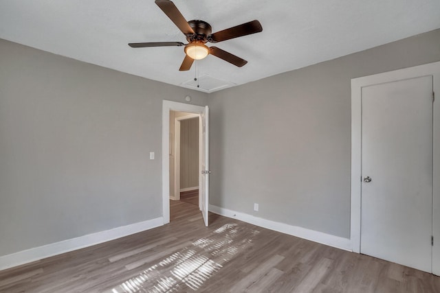 unfurnished room with a ceiling fan, baseboards, and wood finished floors