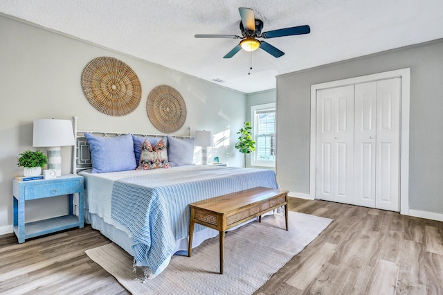 2674 Houston St, North Charleston, SC 29405 - bedroom featuring wood finished floors, baseboards, a ceiling fan, a closet, and a textured ceiling