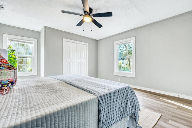 2674 Houston St, North Charleston, SC 29405 - bedroom featuring wood finished floors, baseboards, a ceiling fan, a textured ceiling, and a closet