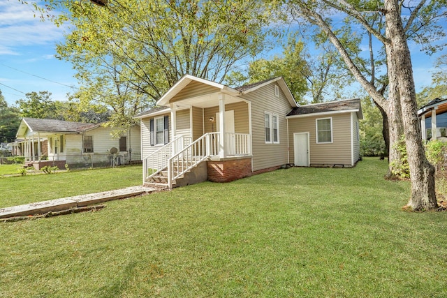 view of front of home with a front lawn and fence