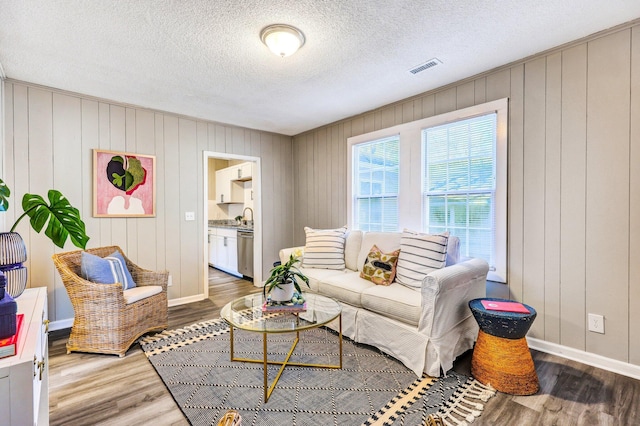 2674 Houston St, North Charleston, SC 29405 - living area with wood finished floors, baseboards, and a textured ceiling