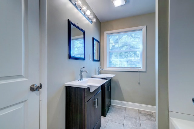 bathroom with tile patterned flooring, vanity, and baseboards