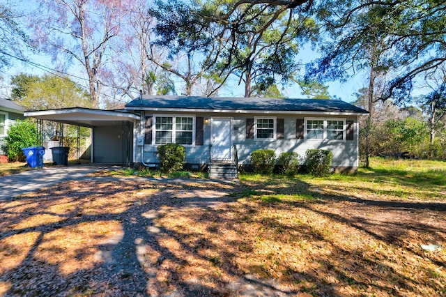 single story home featuring entry steps and driveway