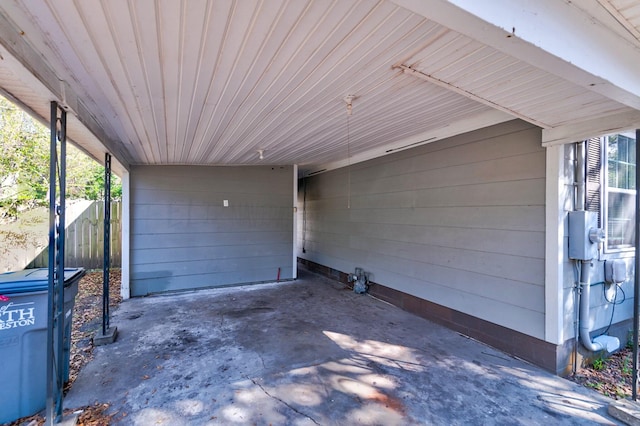 exterior space featuring a carport and fence