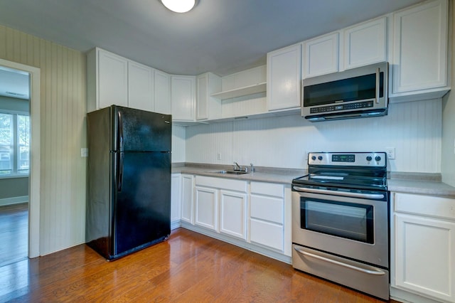 kitchen with open shelves, appliances with stainless steel finishes, dark wood-style flooring, and white cabinets