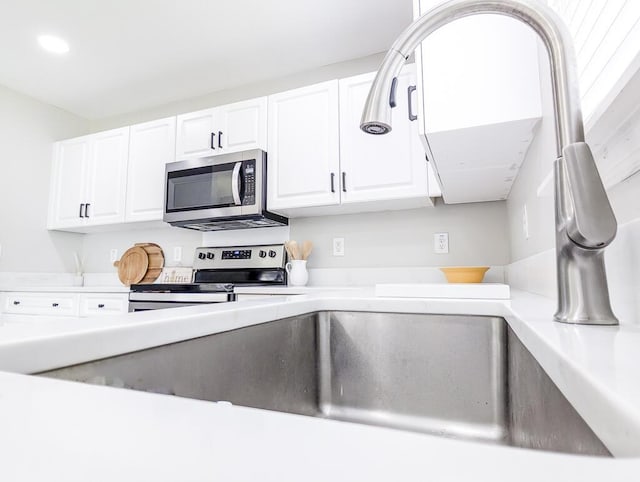 1350 Pinyon Pine Dr, Ladson, SC 29456 - kitchen featuring stainless steel appliances, white cabinetry, light countertops, and recessed lighting