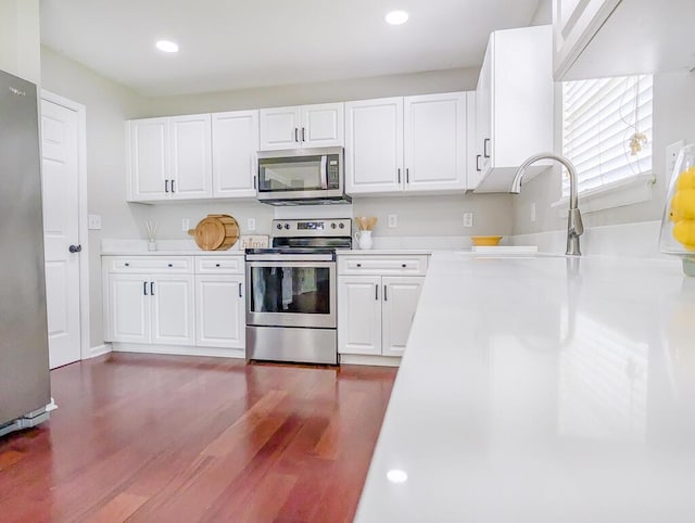 1350 Pinyon Pine Dr, Ladson, SC 29456 - kitchen featuring appliances with stainless steel finishes, light countertops, dark wood-style floors, white cabinets, and recessed lighting