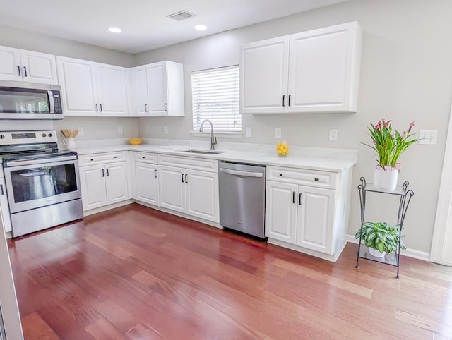 1350 Pinyon Pine Dr, Ladson, SC 29456 - kitchen with stainless steel appliances, dark wood finished floors, light countertops, white cabinets, and recessed lighting