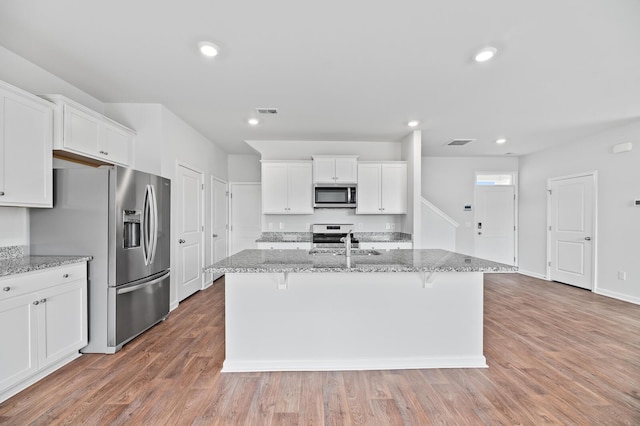 491 Cedarview Rd, Summerville, SC 29486 - kitchen with stainless steel appliances, white cabinets, light stone counters, and recessed lighting
