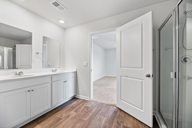 491 Cedarview Rd, Summerville, SC 29486 - bathroom featuring double vanity, wood finished floors, a shower with shower door, and baseboards