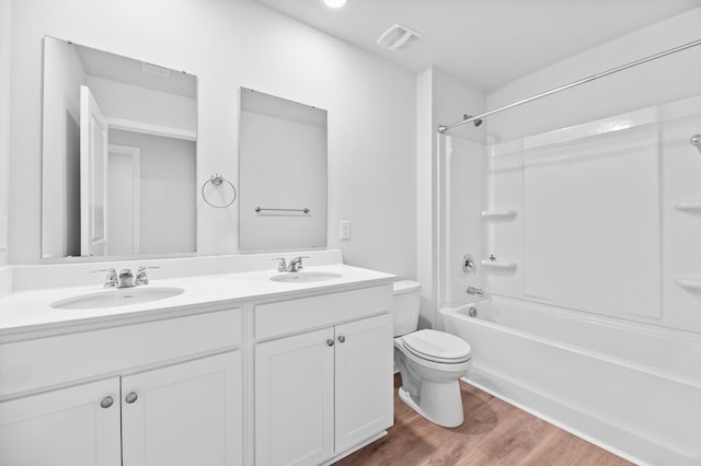 491 Cedarview Rd, Summerville, SC 29486 - bathroom with toilet, wood finished floors, double vanity, and shower / washtub combination