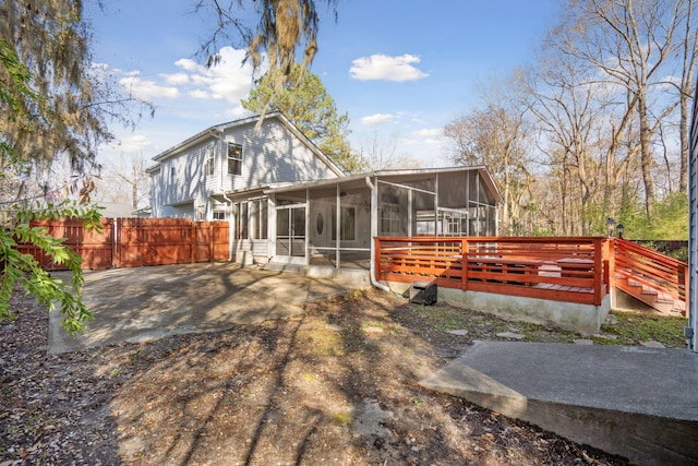 back of house with fence and a sunroom