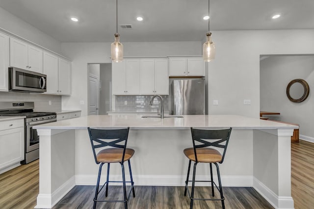 kitchen with white cabinetry, sink, a center island with sink, and appliances with stainless steel finishes