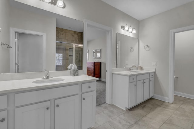 bathroom featuring tile patterned floors, vanity, and a shower with door