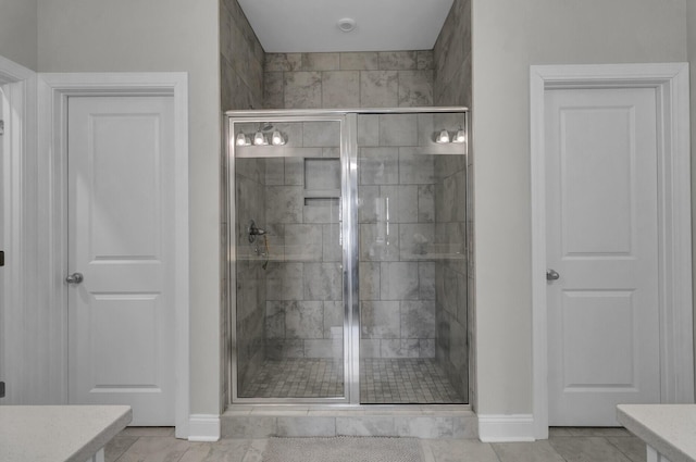 bathroom featuring vanity and a shower with door