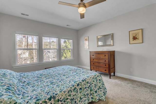 carpeted bedroom featuring ceiling fan and multiple windows