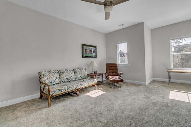 sitting room with a healthy amount of sunlight, light carpet, and ceiling fan