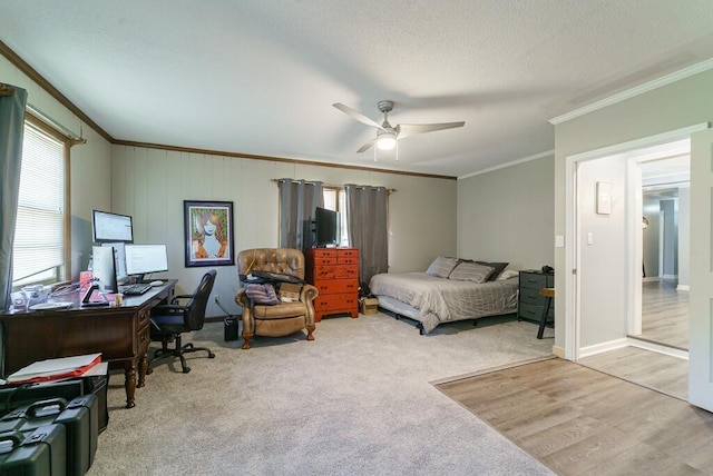 bedroom with a textured ceiling, baseboards, ornamental molding, ceiling fan, and wood finished floors